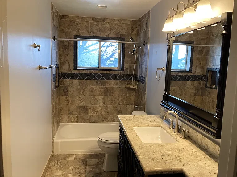 Apartment 18 bathroom and tiled shower surround